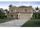 Two-story home with beige exterior and stone accents at 1629 Andover Ridge Dr, Deland, FL 32720