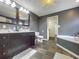 Double vanity bathroom with slate tile floor and garden tub at 33 S Ortman Dr, Orlando, FL 32805