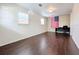 Spacious bedroom with dark wood flooring and large window at 33 S Ortman Dr, Orlando, FL 32805