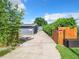 Long driveway leading to the house with wooden fence and hedges at 33 S Ortman Dr, Orlando, FL 32805