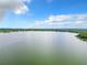 Wide shot of serene lake with lush green shoreline and distant cityscape at 33 S Ortman Dr, Orlando, FL 32805