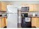 Modern kitchen features stainless steel appliances and wood cabinets at 33 S Ortman Dr, Orlando, FL 32805