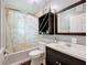 Bathroom with tub shower, updated vanity, and shelving at 33 S Ortman Dr, Orlando, FL 32805