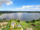 Aerial view of lakefront property, showcasing a house and cityscape in background at 33 S Ortman Dr, Orlando, FL 32805