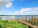 Scenic view of a lake with a wooden dock at 33 S Ortman Dr, Orlando, FL 32805