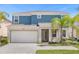 Two-story house with blue and beige exterior at 311 Marcello Blvd, Kissimmee, FL 34746