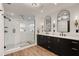 Elegant bathroom with double vanity, large shower, and modern fixtures at 301 Richard Pl, Orlando, FL 32806