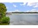 Scenic view of a peaceful lake with lush vegetation and waterfront homes in the distance at 301 Richard Pl, Orlando, FL 32806