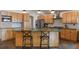 Modern kitchen with light wood cabinets and stainless steel appliances at 301 Richard Pl, Orlando, FL 32806
