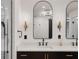 Modern bathroom boasts double sinks and arched mirrors at 301 Richard Pl, Orlando, FL 32806
