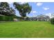 Spacious backyard with lush grass, a large home, and a private fenced area at 301 Richard Pl, Orlando, FL 32806
