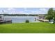 Expansive grassy yard overlooking a lake with a private dock and boathouse at 301 Richard Pl, Orlando, FL 32806