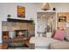 Living room with a cozy stone fireplace and view to entryway at 301 Richard Pl, Orlando, FL 32806