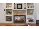 Cozy fireplace with built-in shelving and a warm fire at 301 Richard Pl, Orlando, FL 32806
