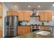 Stainless steel appliances and light wood cabinets in kitchen at 301 Richard Pl, Orlando, FL 32806