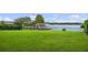 Lakefront property with a large grassy yard, dock, and boathouse at 301 Richard Pl, Orlando, FL 32806