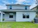 Two story home with gray siding and a covered patio at 4379 Sagefield Dr, St Cloud, FL 34773