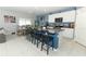 Open kitchen with granite island, stainless steel appliances, and dining area at 1186 August Sky Dr, Deltona, FL 32738