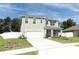 Two-story home with white siding, garage, and landscaped yard at 1186 August Sky Dr, Deltona, FL 32738