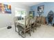 Bright dining room features a large table with seating for six and a decorative tablecloth at 1186 August Sky Dr, Deltona, FL 32738