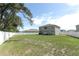 View of backyard, house, and privacy fence at 1186 August Sky Dr, Deltona, FL 32738
