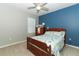 Charming bedroom with a full-size bed and blue accent wall at 1186 August Sky Dr, Deltona, FL 32738