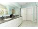 Elegant bathroom with double sinks, granite countertop, and a shower at 1186 August Sky Dr, Deltona, FL 32738