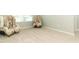 Cozy sitting area with two comfy chairs and neutral carpeting at 1186 August Sky Dr, Deltona, FL 32738