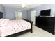 Spacious bedroom with a large bed, dresser, and TV at 1186 August Sky Dr, Deltona, FL 32738