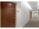 Clean and well-lit hallway with wood doors and neutral walls at 155 S Court Ave # 2208, Orlando, FL 32801