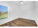 Spacious bedroom with large window, wood-look flooring, and ceiling fan at 3404 Great Pond Dr, Kissimmee, FL 34746