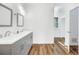 Modern bathroom with double vanity, updated fixtures, and vinyl plank flooring at 3404 Great Pond Dr, Kissimmee, FL 34746