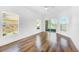 Bright bedroom with wood-look floors, multiple windows and sliding glass doors at 3404 Great Pond Dr, Kissimmee, FL 34746