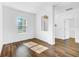 Living room with wood-look floors and large window at 3404 Great Pond Dr, Kissimmee, FL 34746