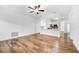 Open living room with wood-look floors and ceiling fan at 3404 Great Pond Dr, Kissimmee, FL 34746