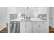 Kitchen island with white cabinets, quartz countertop, and stainless steel dishwasher at 3404 Great Pond Dr, Kissimmee, FL 34746