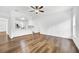 Spacious living room with wood-look floors and a view of the kitchen at 3404 Great Pond Dr, Kissimmee, FL 34746