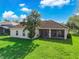 Single-Gathering home with backyard, covered patio and large tree at 3404 Great Pond Dr, Kissimmee, FL 34746