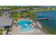 Community pool with lake view and lounge area at 14166 Dove Hollow Dr, Orlando, FL 32824