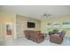 Living room featuring a stone accent wall, leather recliners, and a large TV at 14166 Dove Hollow Dr, Orlando, FL 32824
