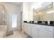 Bathroom with double vanity, walk-in shower, and private access at 8841 Rhodes St, Kissimmee, FL 34747