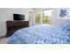 Bedroom with king-size bed, dresser, and a TV at 8841 Rhodes St, Kissimmee, FL 34747