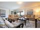 Spacious living room with neutral colored couches and large windows at 8841 Rhodes St, Kissimmee, FL 34747