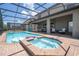 Inviting pool and spa with screened patio and lounge chairs at 8841 Rhodes St, Kissimmee, FL 34747
