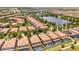 Wide aerial view of community with lake and numerous houses at 8841 Rhodes St, Kissimmee, FL 34747