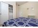 Bright bedroom with a blue and white comforter and built-in shelving at 8841 Rhodes St, Kissimmee, FL 34747
