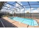 Pool and spa with screened enclosure and floating devices at 8841 Rhodes St, Kissimmee, FL 34747