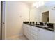 Bathroom with double vanity, granite countertop and large mirror at 8841 Rhodes St, Kissimmee, FL 34747