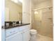 Bathroom with granite countertop, white cabinets, and a glass shower at 8841 Rhodes St, Kissimmee, FL 34747