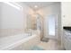 Elegant bathroom with soaking tub, walk-in shower, and private access at 8841 Rhodes St, Kissimmee, FL 34747